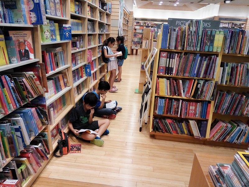 Children reading books at the Kinokuniya bookstore, Jurong East Mall, Singapore.