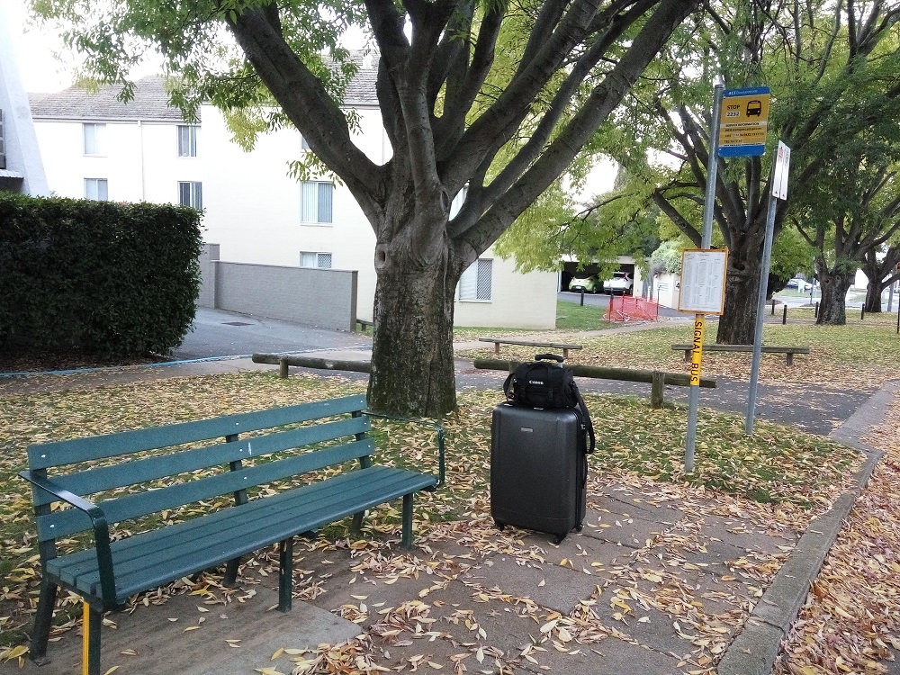 My camera, travel bag, and the empty bus stop! I was waiting for my bus to go to the city centre and clicked a few pics.