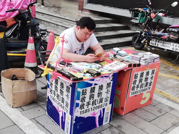 Nantong city center - A local vendor relaxing in his spare time.