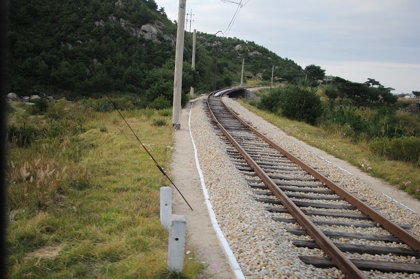 The North Korean railway tracks passing through the mountains. 