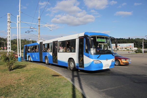 A Pyongyang bus passing near the Arch of Triumph. 