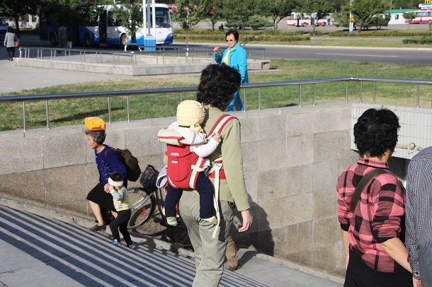 How is life in Pyongyang? A North Korean mom carrying her baby giving clues. 