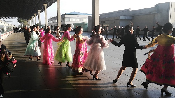 North Korean traditional dress – mass dance at Sinuiju Cheongnyeon Railway Station.