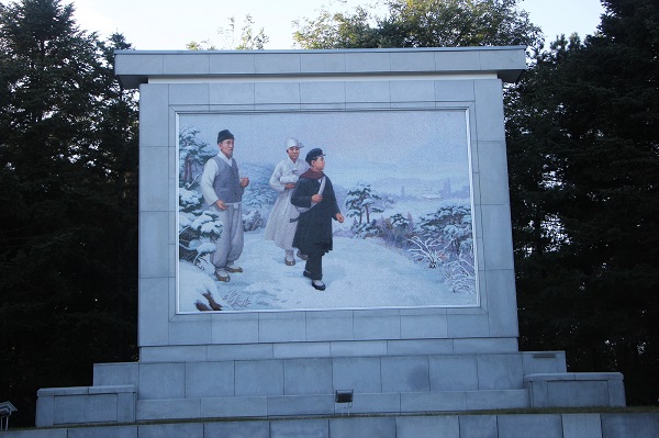 A poster in Pyongyang displaying departure of Kim Il-sung to China when he was 10 years old.
