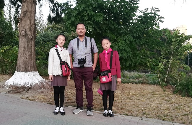 One fine evening in Pyongyang with North Korean students -- they were returning from school and we got the photo near the Mansudae Fountain Park. 