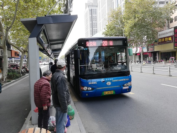 A local Zhenjiang bus coming to a bus stop.