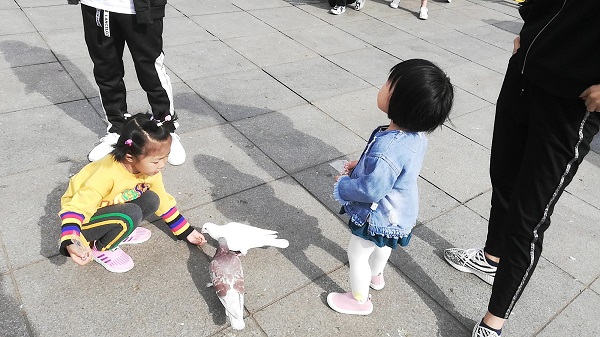 Cute Chinese kids playing near Dalian Zoo. 