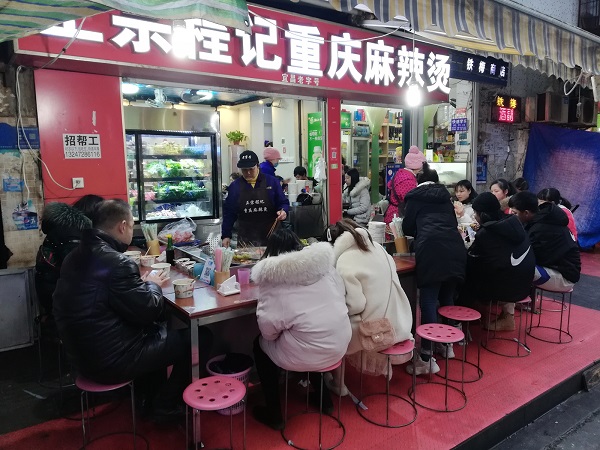 Local enjoying Chinese street food in Yichang’s CBD night market.